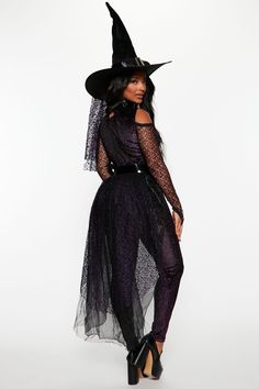 a woman in a witch costume posing for the camera