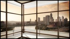 an empty room with large windows overlooking the cityscape and river in the foreground