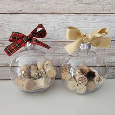 two glass ornaments with corks in them