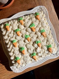 a cake with carrots on it sitting on a table