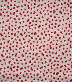 the fabric has strawberries on it and is white with red dots, which are all over