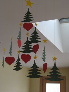 christmas decorations hanging from the ceiling in a room