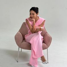 a woman sitting in a chair with her legs crossed