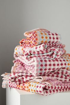 a stack of towels sitting on top of a white table