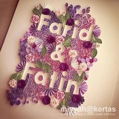 the word fair and fair is made out of paper flowers on a white sheet with purple leaves