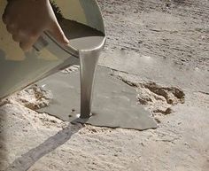 a person is pouring cement into a bucket