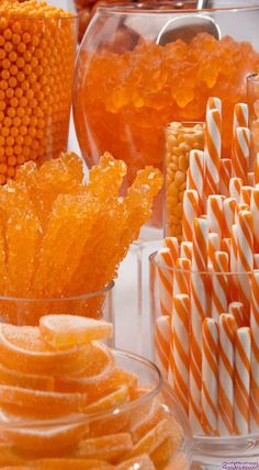 orange and white striped straws in clear glass vases with nail polish on top