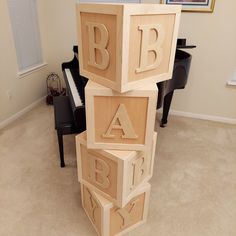 the letters are made out of wood blocks and placed on top of each other in front of a piano