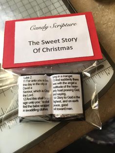 the sweet story of christmas book is in its plastic wrapper next to a ruler