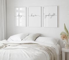 two framed art prints above a bed in a white bedroom with linens and pillows