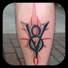 a person with a tattoo on their leg that has the letter b and flames coming out of it