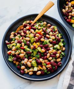 two black - eyed peas and broccoli in a bowl with a wooden spoon