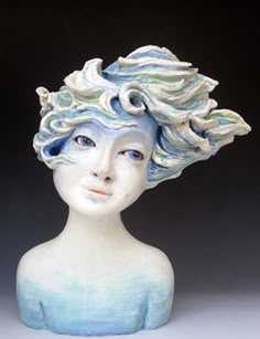 a white and blue busturine with wavy hair