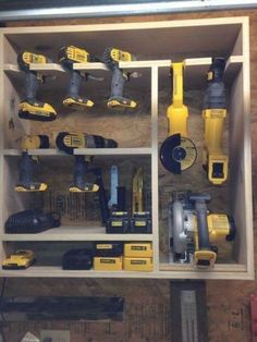 a cabinet filled with lots of tools and power drillers on top of wooden shelves