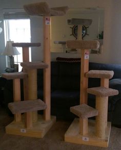 two cat trees in the middle of a living room