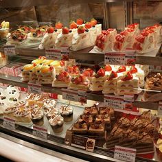 a display case filled with lots of different types of desserts