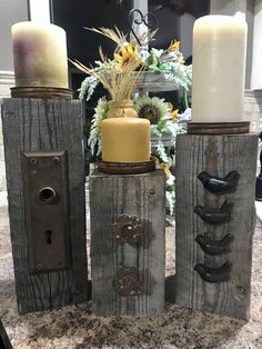 three candles are sitting on top of some wood