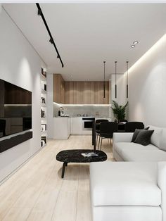 a modern living room with white furniture and wood flooring