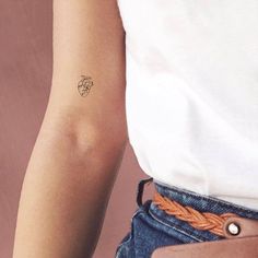 a woman's arm with a tattoo on the left side of her right arm