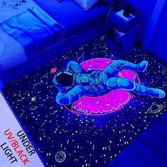 an image of a man laying on the ground in front of a bed with blue lights