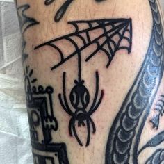 a man with a spider web tattoo on his leg