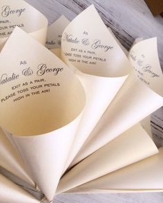 folded wedding programs are displayed on a table