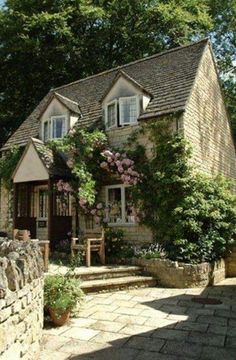 the house is surrounded by trees and flowers