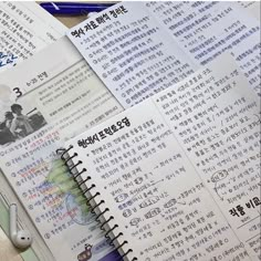 an open book with chinese writing on it and some other papers next to it that have been written in different languages