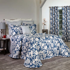 a blue and white bed in a bedroom