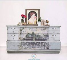 an old dresser is decorated with flowers and pictures