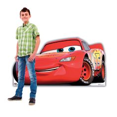 a young boy standing next to a cartoon character from the disney pixar movie