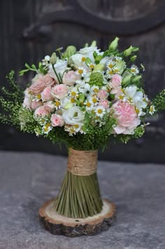 a bouquet of flowers in a vase on a table