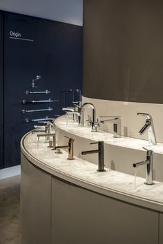 a bathroom with two sinks and three faucets