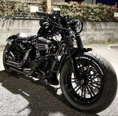 a black motorcycle parked on top of a parking lot