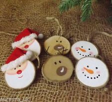 wooden slices with snowmen and santa hats on them