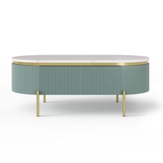 an oval coffee table with gold legs and a green stripe on the top, against a white background