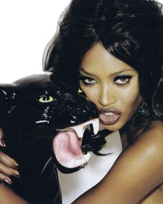 a woman holding a black cat with her mouth open