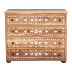 a wooden dresser with white and brown designs on it