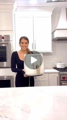 a woman is holding a cake in the kitchen