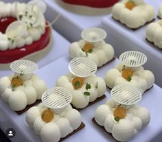 several trays filled with different types of desserts on top of eachother