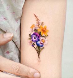 a woman's arm with flowers on it