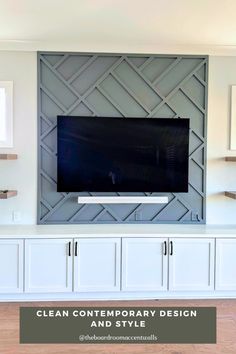 a tv mounted on top of a white entertainment center with the words clean contemporary design