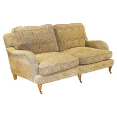 an old fashioned couch is upholstered with fabric