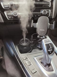 the interior of a car with steam coming out of it's air vent and steering wheel