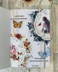 an open book with butterflies and flowers on it