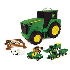 a toy tractor and farm equipment set on a white background