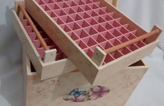 a wooden box filled with lots of pink boxes