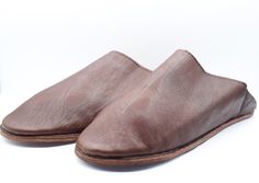 Genuine leather slipper, with a best doble calf leather sole, we can wear it comfortably wherever you go. Those Moroccan babouches material can keep your feet warm even in a storm. Best gift as Moroccan shoes or leather mules. Morocco is a world leader in the art of leather production and the leather used for leather mules is the softest available. The leather is still dyed in a natural process which can be observed in the tanneries of the medina. Hurry, take advantage of our best offers ever: ? Casual Slip-on Slippers With Leather Lining, Brown Slip-on Indoor Clogs, Brown Slip-on Clogs For Indoor Use, Classic Brown Slippers With Leather Sole, Brown Indoor Clogs With Rubber Sole, Classic Brown Slip-on Slippers, Brown Round Toe Clogs For Indoor, Indoor Slip-on Slippers With Leather Footbed, Leather Footbed Slip-on Indoor Slippers