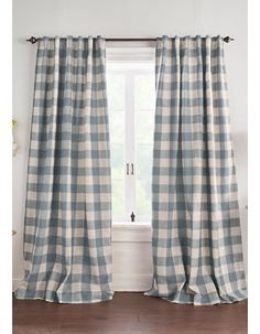 the curtains in this living room are lined with grey and white checkered linens