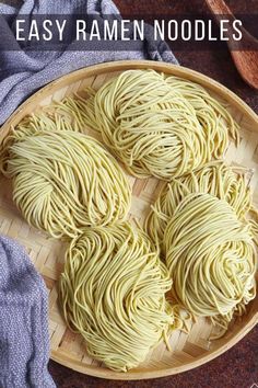 some noodles are in a wooden bowl on a table